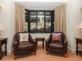A living room with two armchairs and a side table at Sandsgate near Chagford