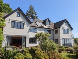 An exterior view of a house with windows and landscaping at Sandsgate near Chagford