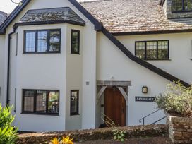 The exterior of Sandsgate with windows and a door at Spinster's Rock, near Chagford