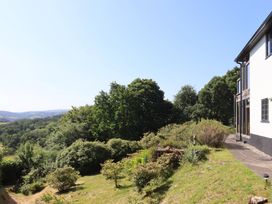 A garden with trees and a house at Sandsgate near Chagford