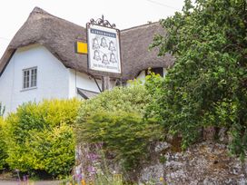 A pub sign for The Ring of Bells Inn with thatched roof at Little Gate Cottage in North Bovey
