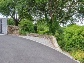 An outdoor entrance with a stone wall and trees at Little Gate Cottage North Bovey