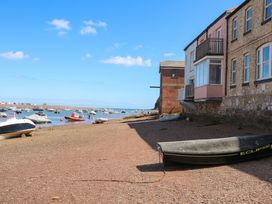 A view of boats at the shore by a building at The Dolphins in Shaldon