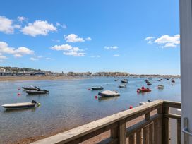A view of boats on water with a shoreline at The Dolphins in Shaldon