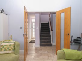 A hallway with a staircase and seating area at The Dolphins in Shaldon