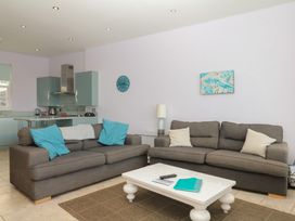 A living room with a sofa and coffee table at The Dolphins in Shaldon