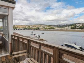 An outdoor deck with a view of the river and boats at The Dolphins in Shaldon