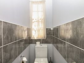 A bathroom with a toilet and window at The Dolphins in Shaldon