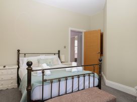 A bedroom with a bed and a chest of drawers at The Dolphins in Shaldon