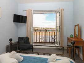 A bedroom with a bed and television at The Dolphins in Shaldon