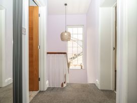 A hallway with a window and doors at The Dolphins in Shaldon