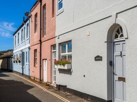 A street view of buildings in varying colors at The Dolphins in Shaldon