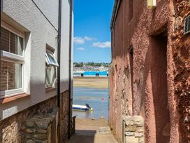 An outdoor view between buildings leading to a boat at The Dolphins in Shaldon