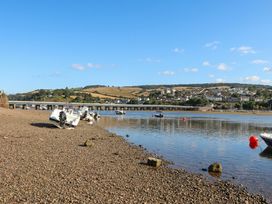 A river with boats and a bridge visible at The Dolphins in Shaldon