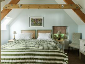 A bedroom with a bed and bedside table at Sandridge Boathouse Stoke Gabriel