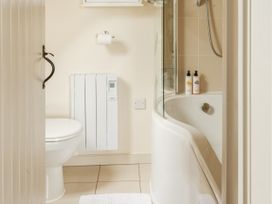 A bathroom with a bathtub and toilet at Sandridge Boathouse Stoke Gabriel