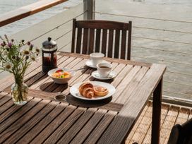 An outdoor seating area with a table set for breakfast at Sandridge Boathouse Stoke Gabriel