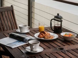 A table with coffee, pastries and fruit at Sandridge Boathouse in Stoke Gabriel