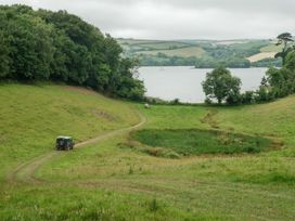 A landscape with a vehicle near a lake at Sandridge Boathouse in Stoke Gabriel