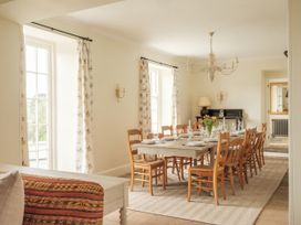 A dining room with a large table and chairs at Sandridge Barton in Stoke Gabriel