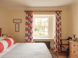A bedroom with a bed and window at Sandridge Barton Stoke Gabriel
