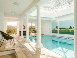 An indoor pool area with columns and artwork at Sandridge Barton Stoke Gabriel