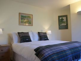 A bedroom with a bed and wall art at The Barn in Compton Bishop, near Cheddar