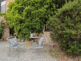 A garden with chairs and a table at The Barn in Compton Bishop, near Cheddar