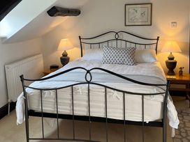 A bedroom with a bed and bedside lamps at Castle View in Dunster