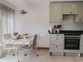 A kitchen with a table set for tea at The Old Log Shed in Honiton