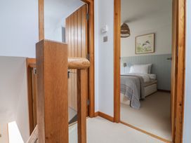 A hallway with a view into a bedroom at The Old Log Shed in Honiton