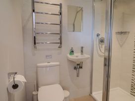 A bathroom with a toilet and washbasin at The Old Log Shed in Honiton