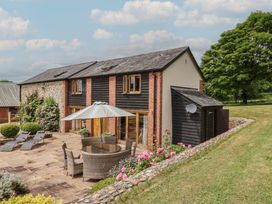 An outdoor area with a table and chairs at The Old Log Shed in Honiton
