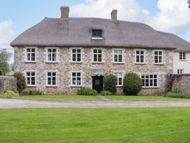A stone house with a thatched roof at Hornshayne Farmhouse, Farway, near Honiton