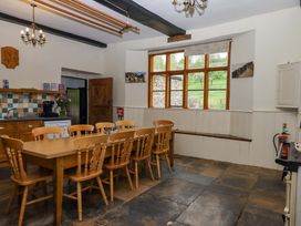 A kitchen with a dining table and chairs at Hornshayne Farmhouse Farway, near Honiton
