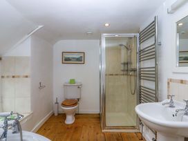 A bathroom with a shower, toilet, and sink at Hornshayne Farmhouse in Farway, near Honiton