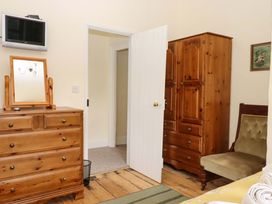 A bedroom with a chest of drawers and wardrobe at Hornshayne Farmhouse Farway near Honiton