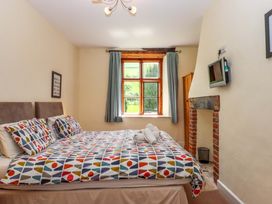 A bedroom with a bed and a window at Hornshayne Farmhouse, Farway, near Honiton