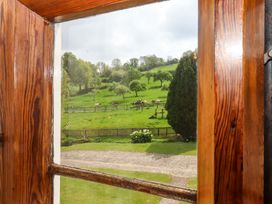 A view of cows on farmland through a window at Hornshayne Farmhouse near Honiton
