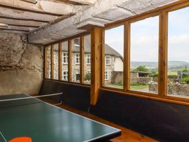 A games room with a ping pong table and a view of the countryside at Hornshayne Farmhouse in Farway, near Honiton