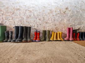 Various pairs of wellington boots lined up at Hornshayne Farmhouse, Farway, near Honiton