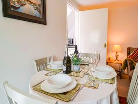 A dining table with plates and drinks at Poppy Cottage in Charlton Marshall