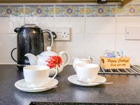 A kettle and tea set on a countertop at Poppy Cottage Charlton Marshall