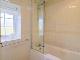 A bathroom with a bath tub and shower at Poppy Cottage Charlton Marshall