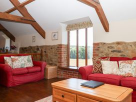 A living room with sofas and a coffee table at The Cottage in Sampford Courtenay