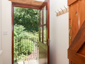 An entrance with an open door and hooks at The Cottage in Sampford Courtenay