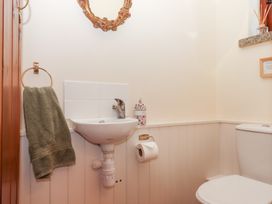 A bathroom with a sink and toilet at The Cottage in Sampford Courtenay