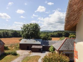 A view of fields and barns from above at The Cottage in Sampford Courtenay
