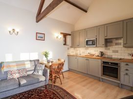 A kitchen with seating area and dining table at Miners Dry, Gulworthy, near Tavistock