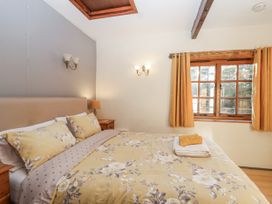 A bedroom with a bed and window at Miners Dry in Gulworthy, near Tavistock